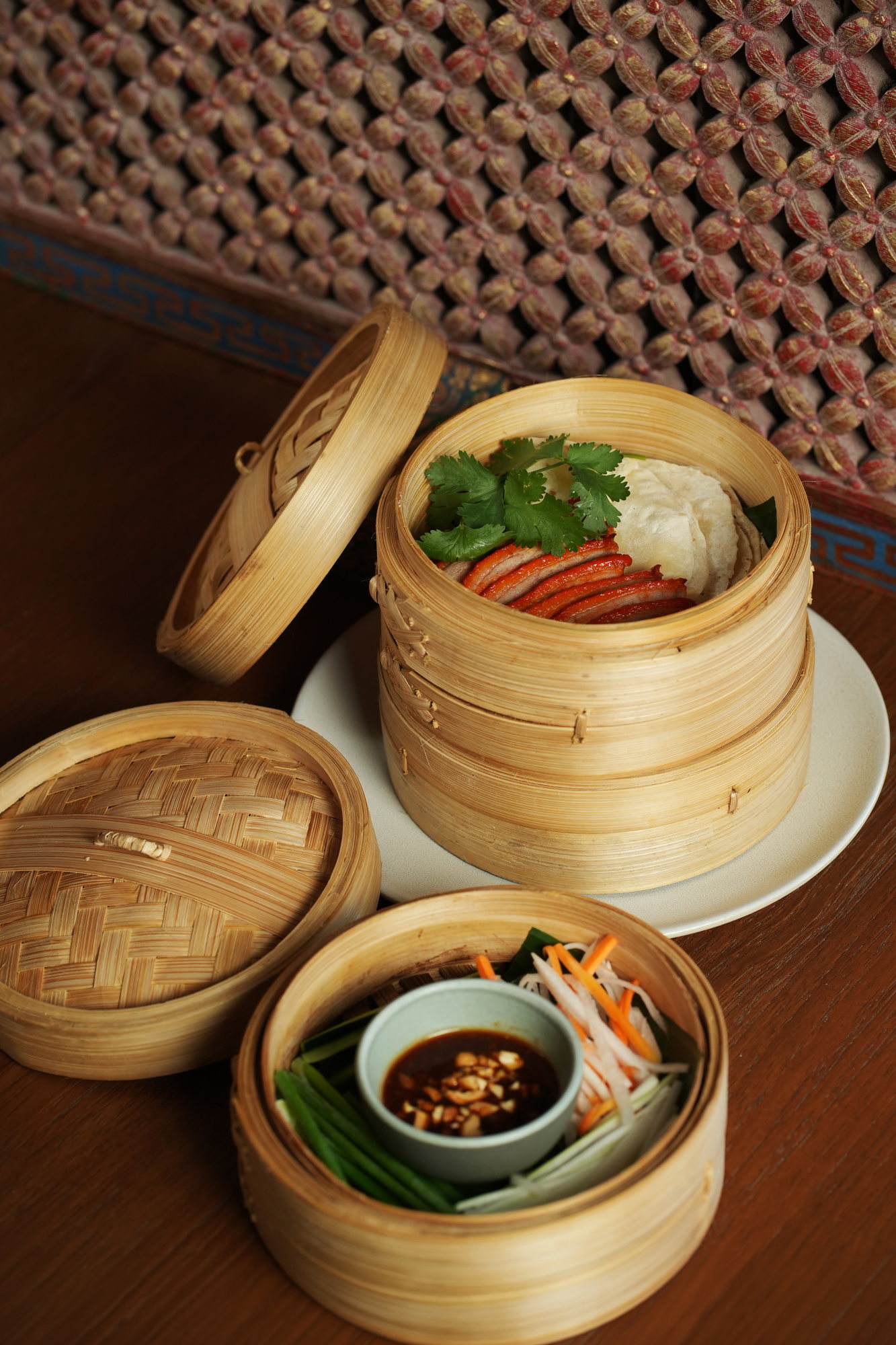 Sliced roast duck with coriander and crackers served in a bamboo steamer at ARUM, Paradisus by Melia Bali