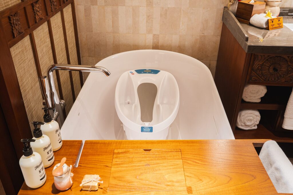 A baby bathtub with a built-in scale, set inside the bathtub of a Family Concierge suite