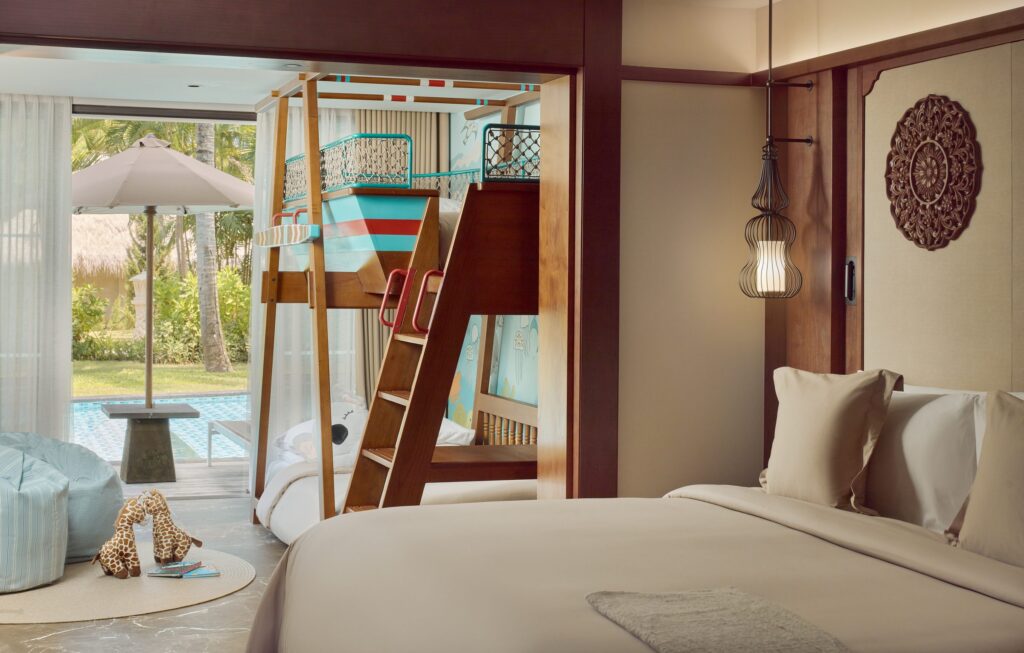 A Family Concierge Junior Suite Lagoon Access at Paradisus by Meliá Bali, with a boat-shaped bunk bed for children and steps out to the lagoon pool