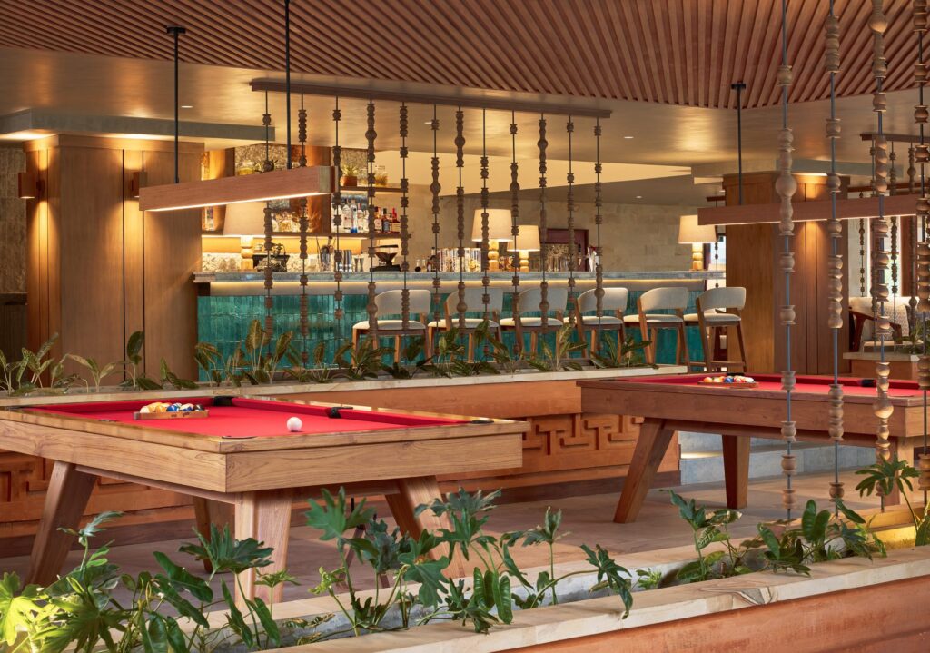 Ginger Bar at Paradisus by Meliá Bali, with two teak pool tables in front of a turquoise-tiled bar