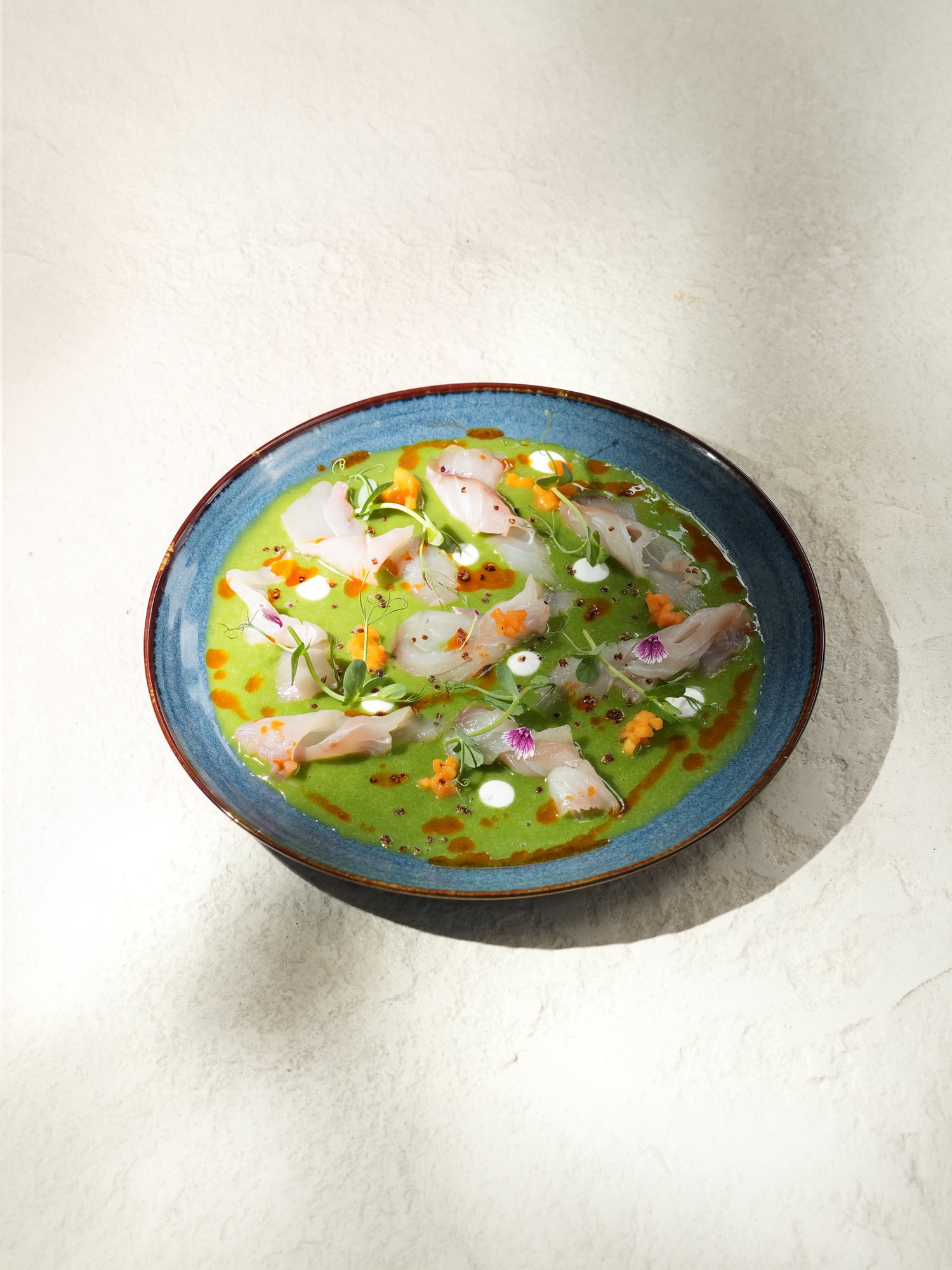 Ceviche of white fish in a green herb leche de tigre with sweet potato and chilli oil at Kanna Beach, Paradisus by Melia Bali