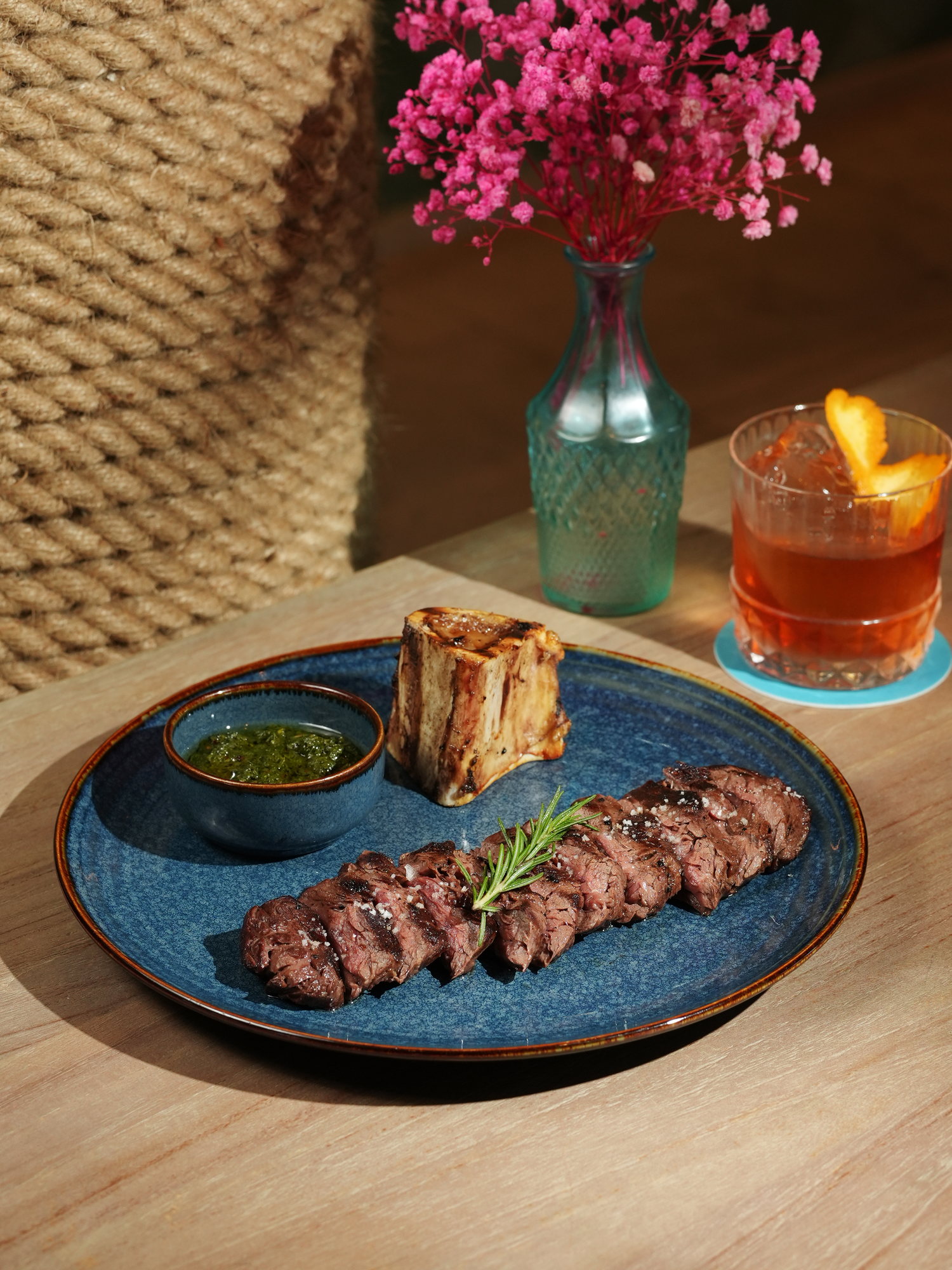 Sliced grilled steak with roasted bone marrow and chimichurri at Kanna Beach, Paradisus by Melia Bali