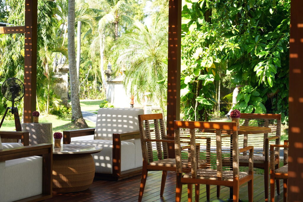 Lagoon Bar at Paradisus by Meliá Bali, a shaded timber deck with woven chairs looking onto the garden and lagoon