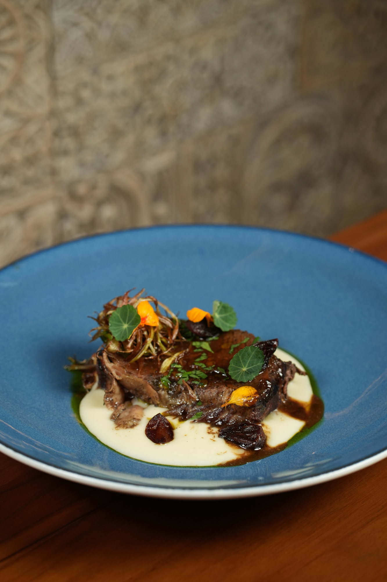 Braised beef with potato puree, roasted shallots and nasturtium leaves at Malva, Paradisus by Melia Bali