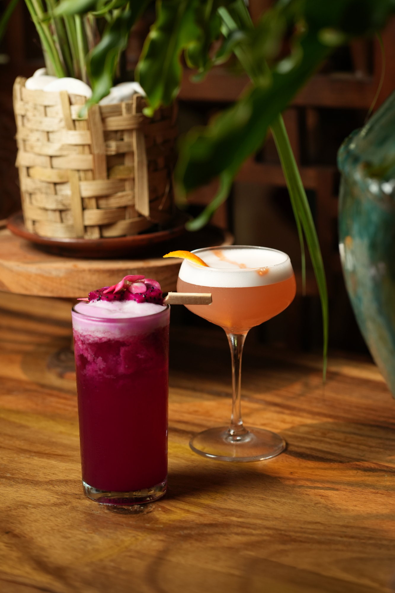 Two cocktails at Malva, Paradisus by Melia Bali: a dragon fruit highball and a citrus sour with orange peel