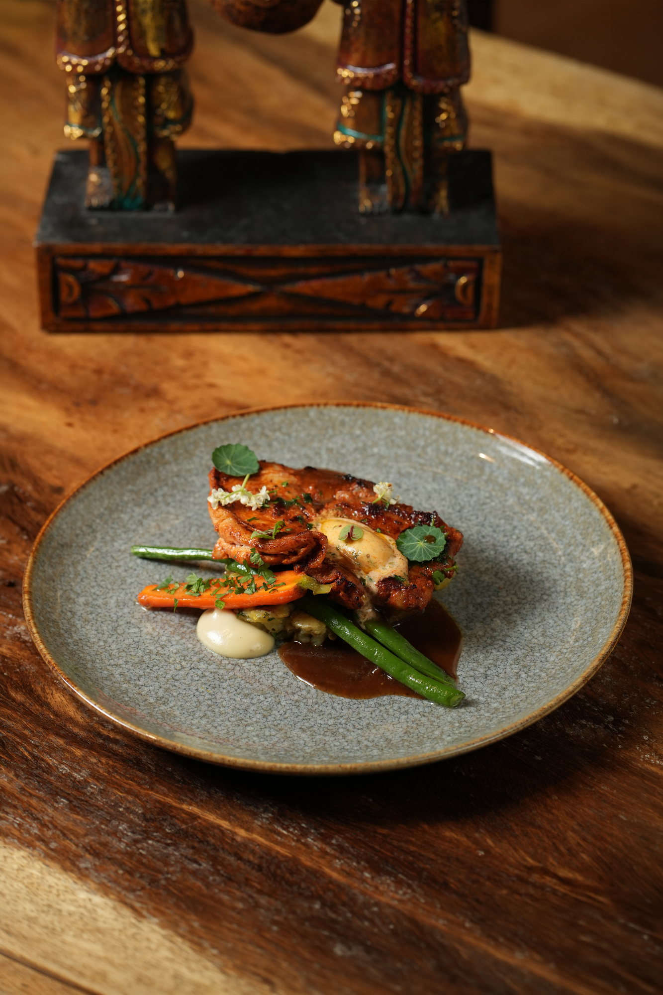 Grilled chicken with glazed carrot, green beans and a dark jus at Malva, Paradisus by Melia Bali