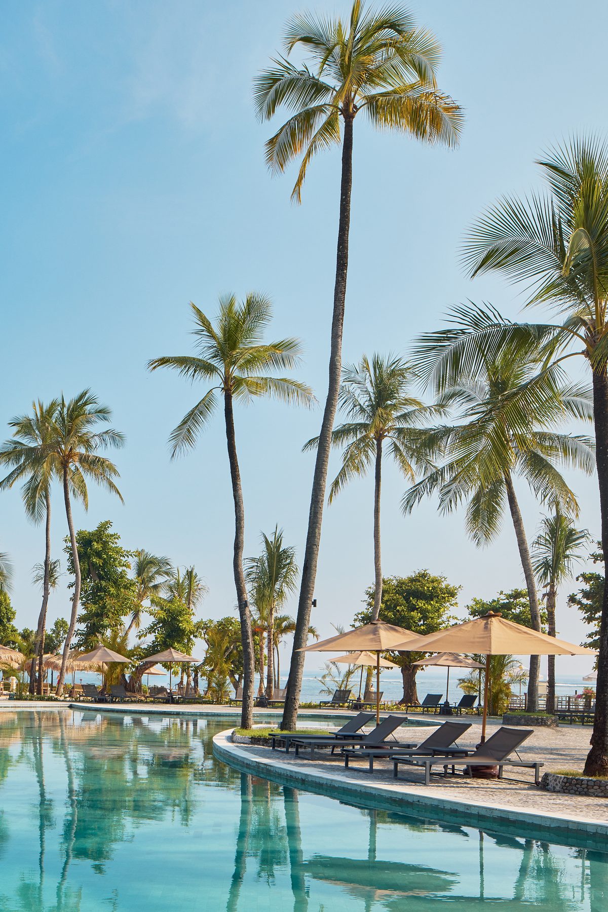 Main pool at Paradisus by Meliá Bali, lined with palm trees in Nusa Dua