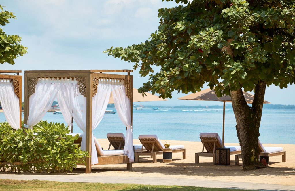 Beachfront cabanas and sun loungers on the Nusa Dua beach at Paradisus by Meliá Bali