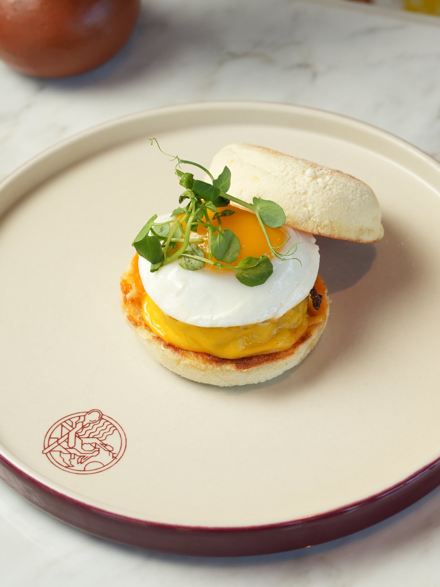 A poached egg with melted cheese in a toasted English muffin at Peseta, Paradisus by Melia Bali