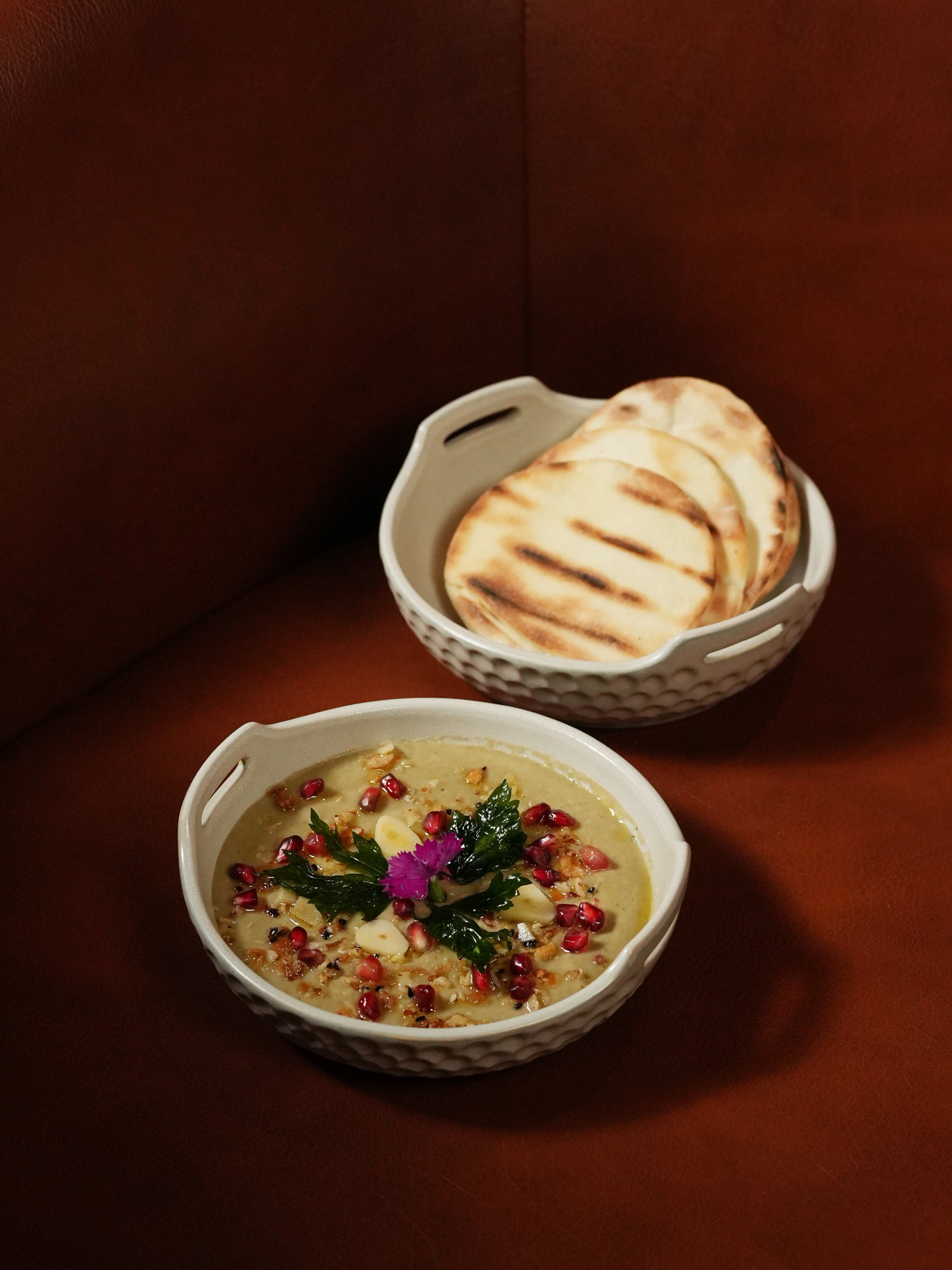 A smoked aubergine dip with pomegranate, walnuts and parsley, served with grilled pita at Samira, Paradisus by Melia Bali