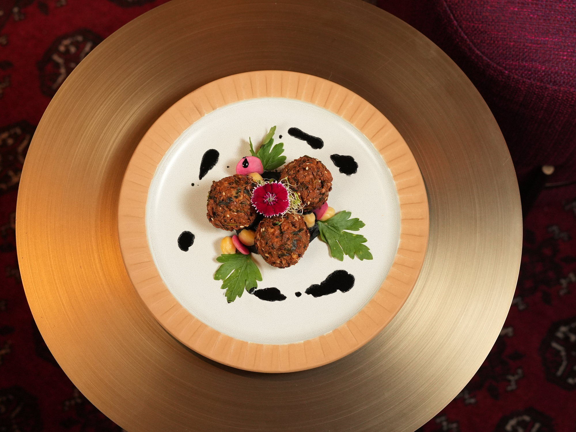 Three falafel with chickpeas, pickled radish and a dark sauce at Samira, Paradisus by Melia Bali