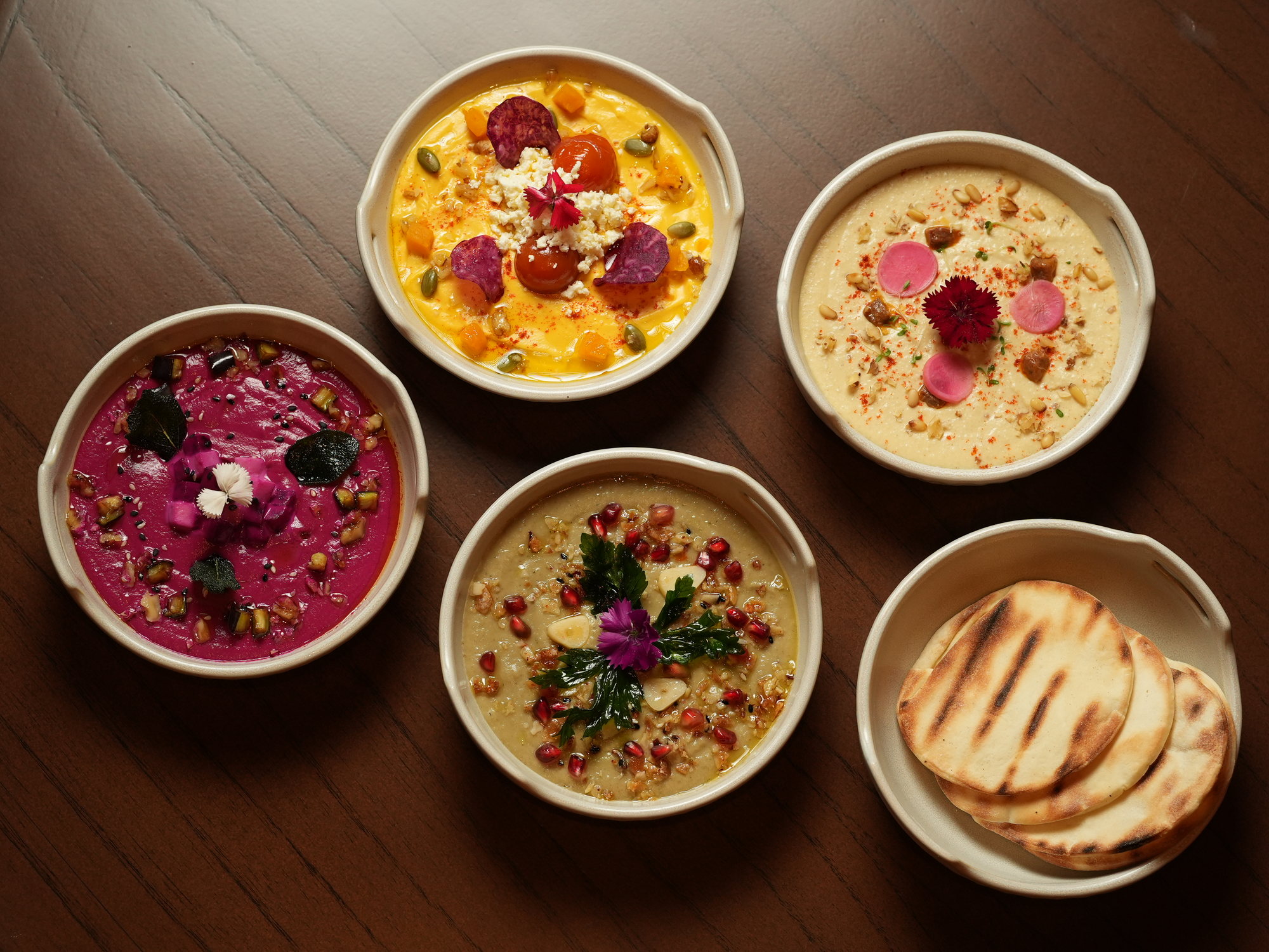 Five mezze bowls at Samira, Paradisus by Melia Bali: hummus, beetroot, pumpkin and baba ganoush with grilled pita