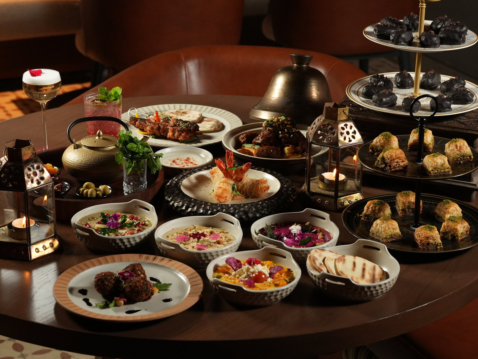 A table of Middle Eastern dishes at Samira, Paradisus by Melia Bali: mezze bowls, kebabs, falafel, kataifi prawns, baklava and chocolate dates by lantern light