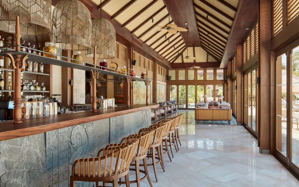 Santé Bar at The Reserve, Paradisus by Meliá Bali, a carved stone counter with rope-backed stools under a high timber roof