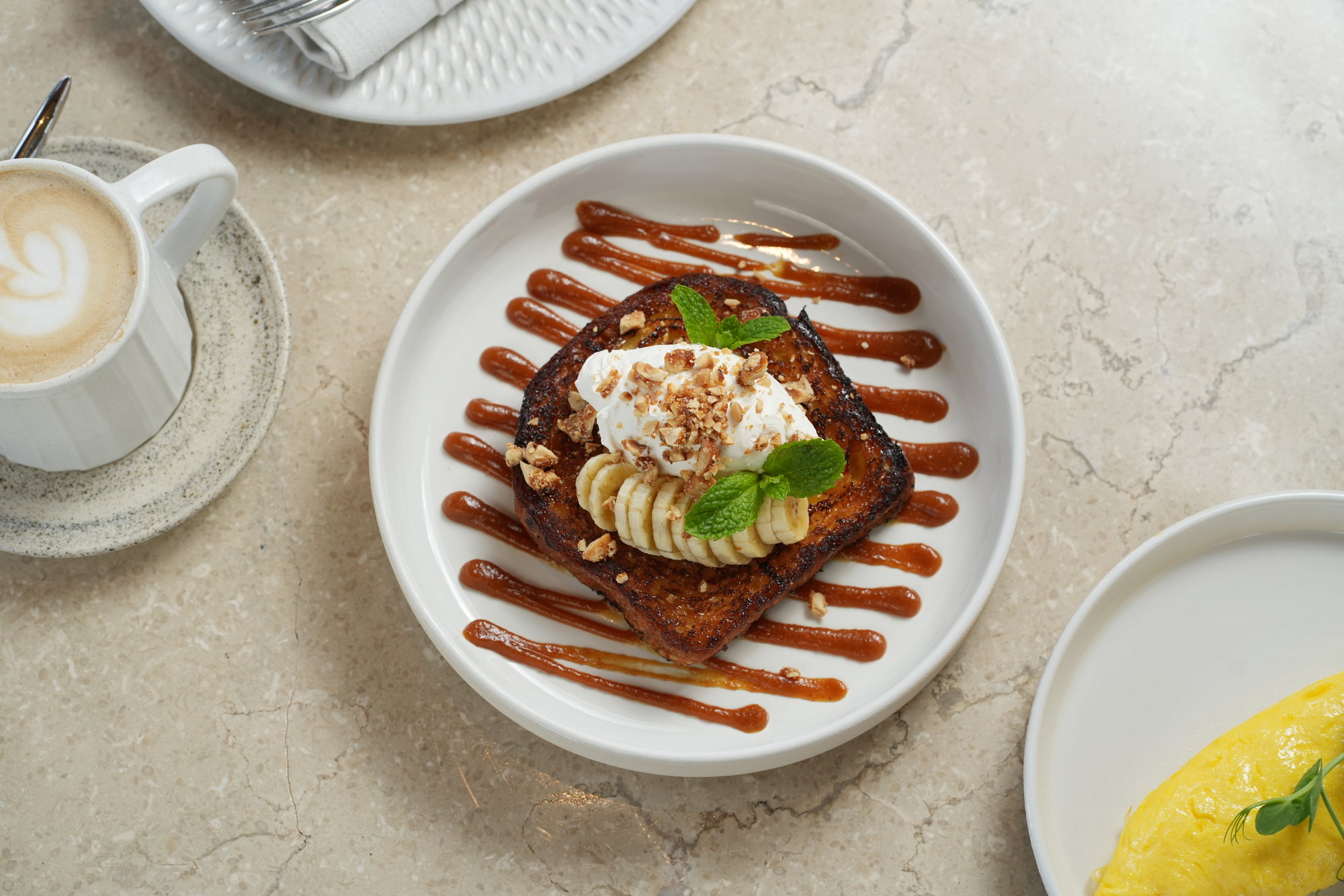 French toast with banana, whipped cream, toasted hazelnuts, mint and caramel sauce at Sante, Paradisus by Melia Bali