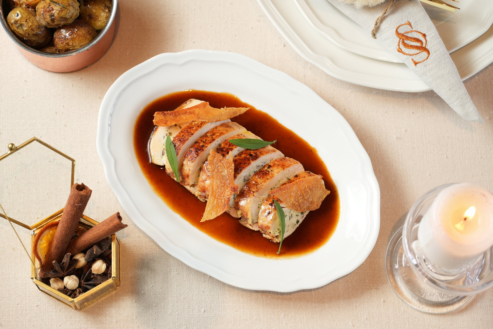 Sliced stuffed chicken breast with crisp skin, tarragon and a dark jus, with rosemary potatoes alongside, at Sante, Paradisus by Melia Bali