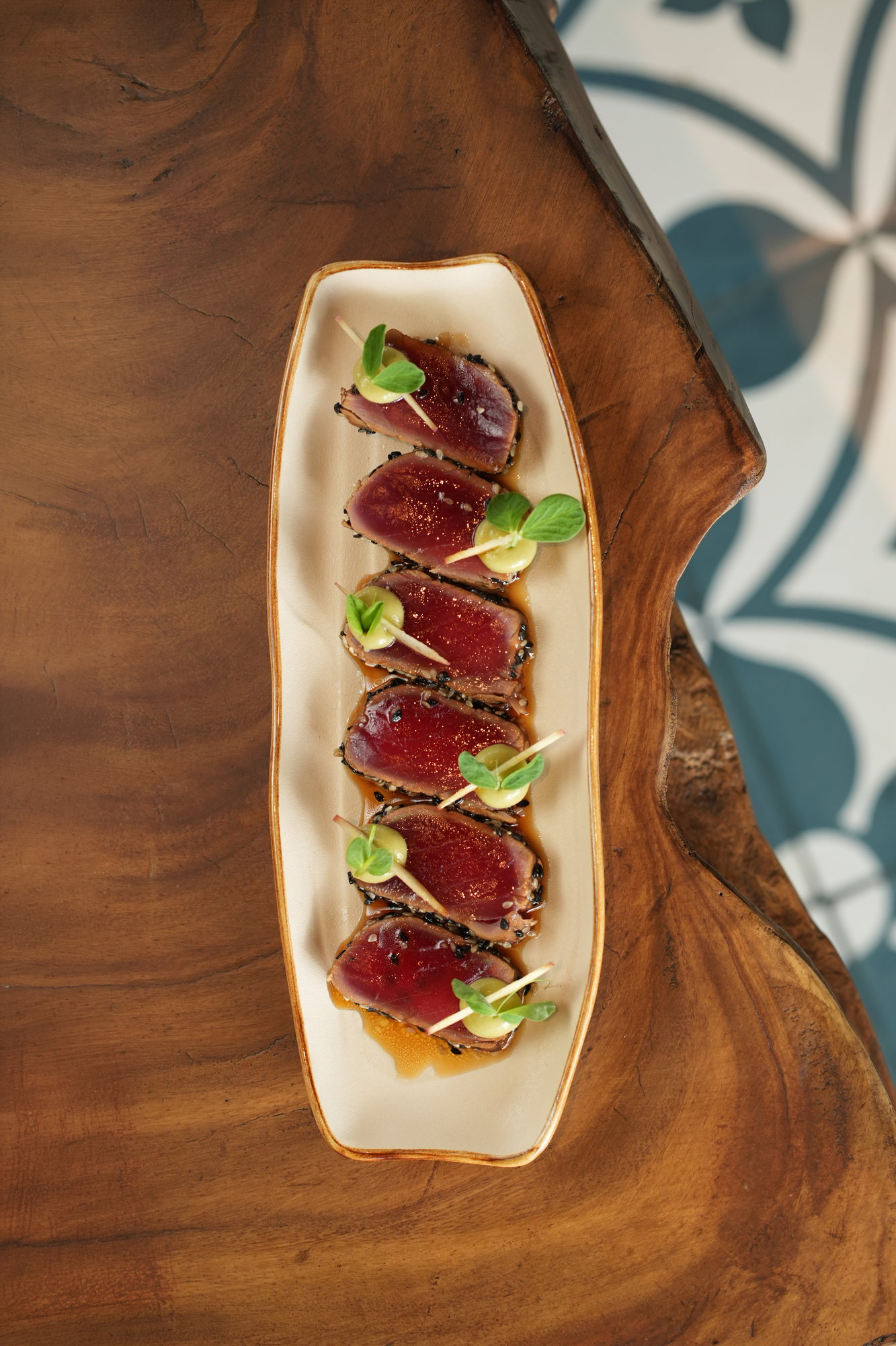 Sesame-crusted tuna tataki sliced on a citrus-soy dressing with avocado cream and apple at Sante, Paradisus by Melia Bali