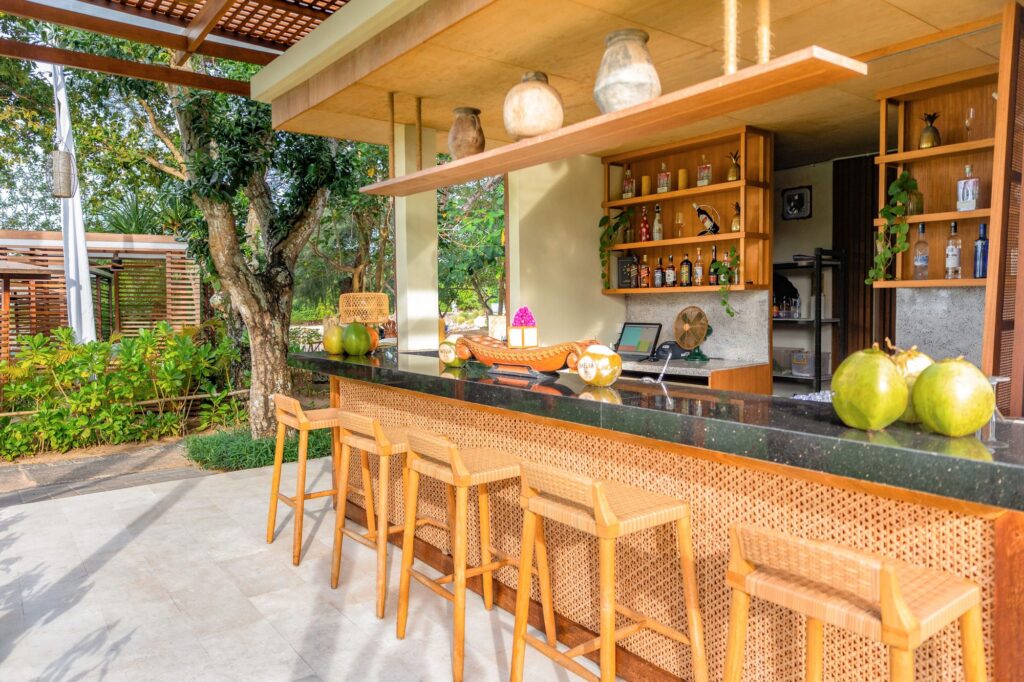 Taman Surya Bar at Paradisus by Meliá Bali, an open garden bar with rattan stools and fresh coconuts on the counter