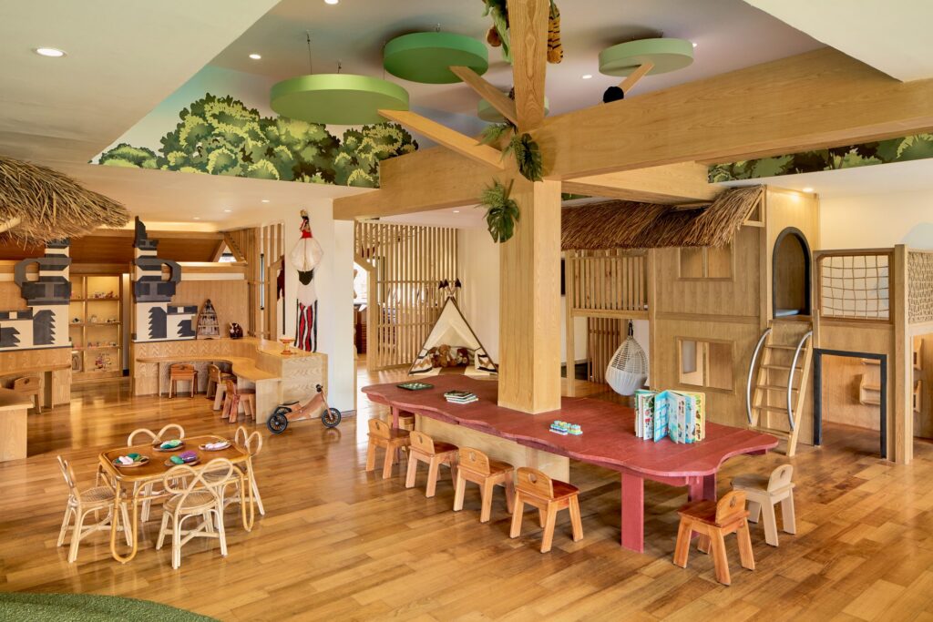 Inside The Kidsdom kids club at Paradisus by Meliá Bali, with a wooden playhouse, tepee and craft tables