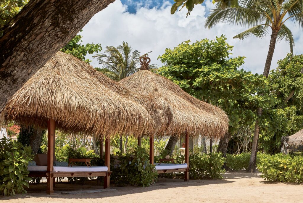 Thatched beach cabanas in The Reserve beach area at Paradisus by Meliá Bali