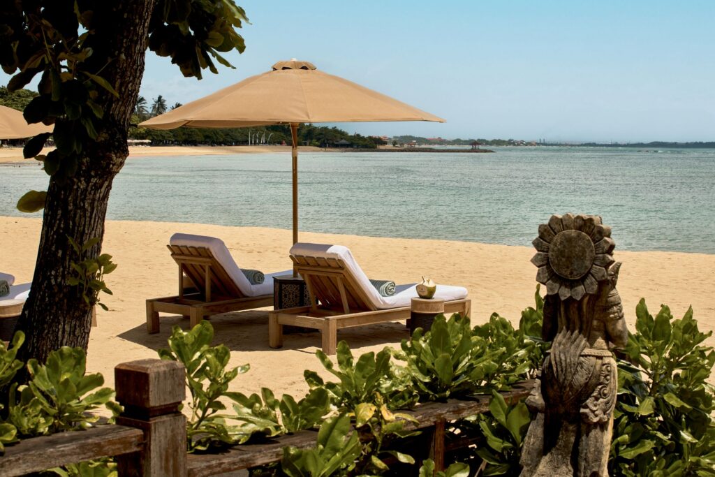 Sun loungers on The Reserve beach area facing the sea in Nusa Dua, Bali