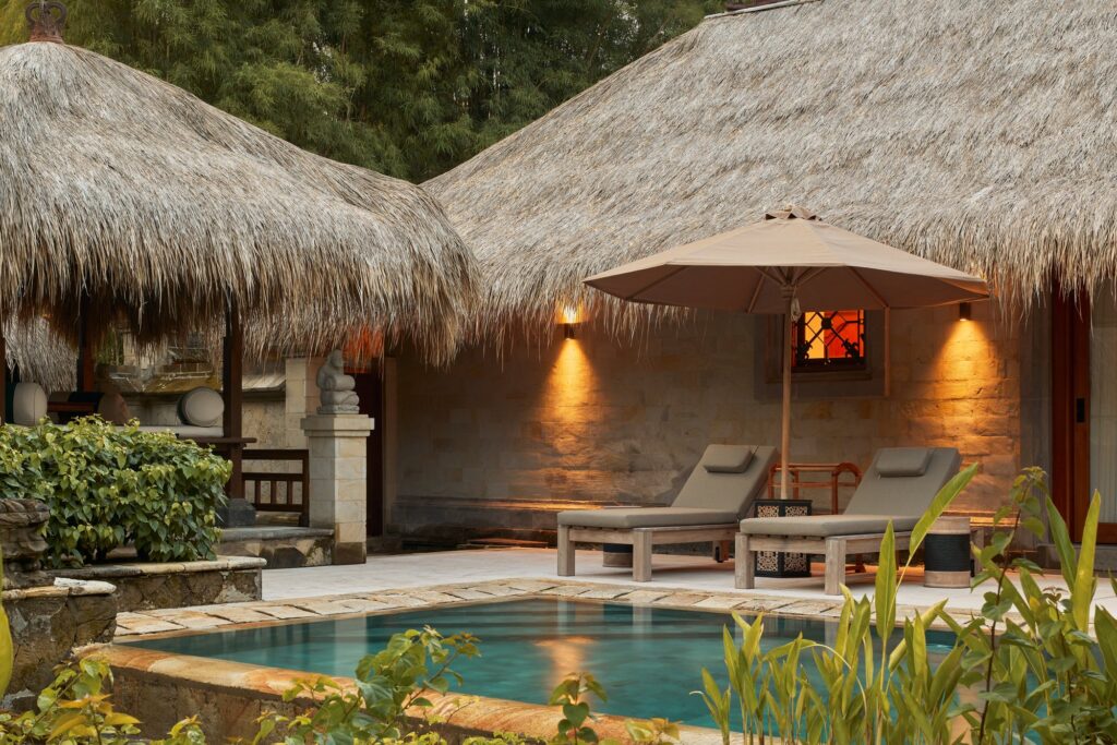 The private pool and sun loungers of a Garden Villa at The Reserve, Paradisus by Meliá Bali, under a thatched roof