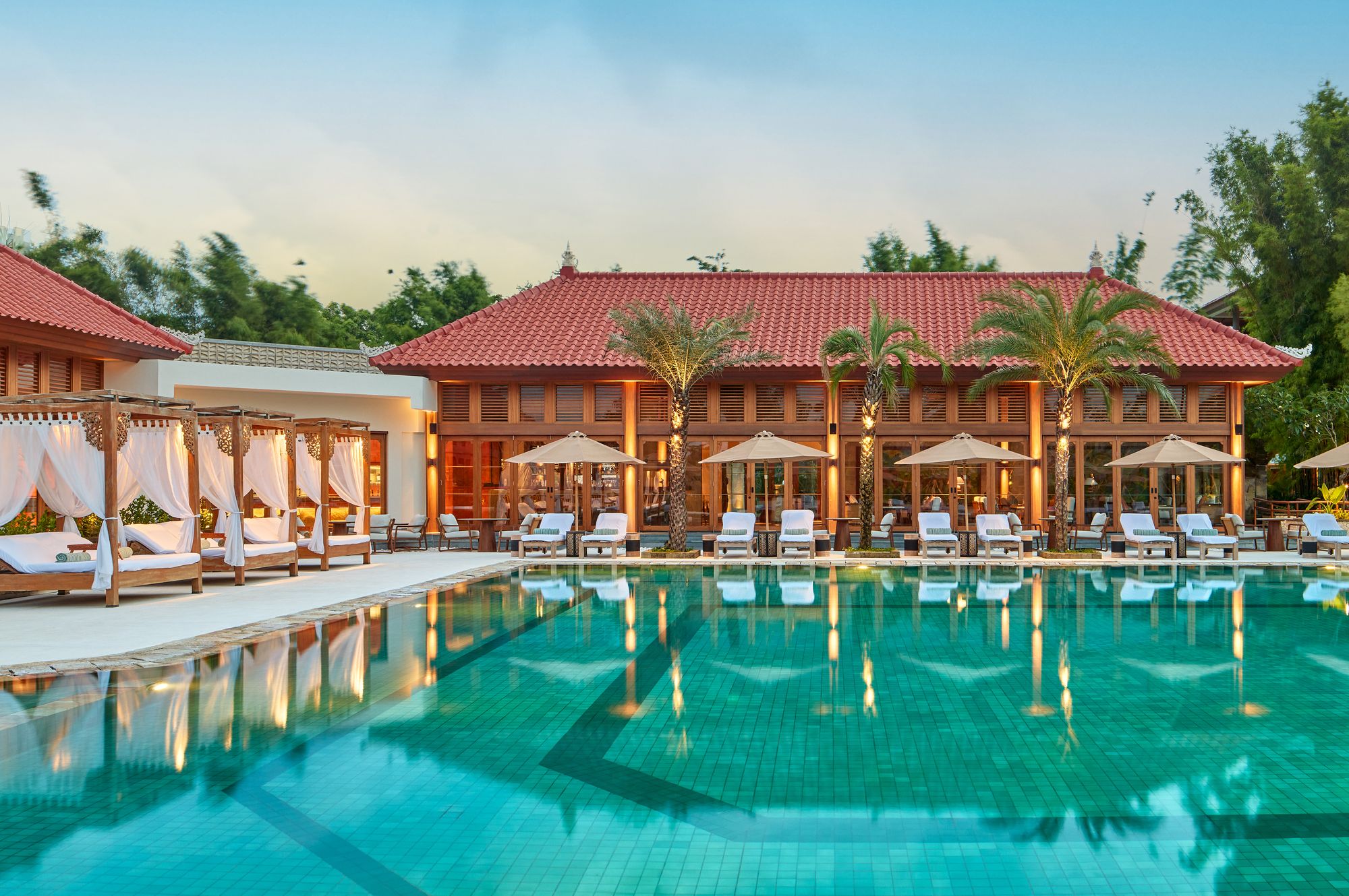 The Reserve pool at dusk, with cabanas and loungers, at Paradisus by Meliá Bali