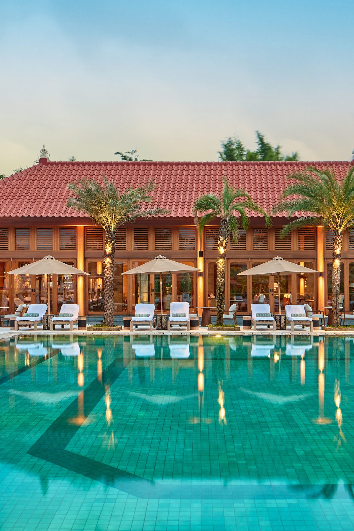 The Reserve pool at dusk, with cabanas and loungers, at Paradisus by Meliá Bali