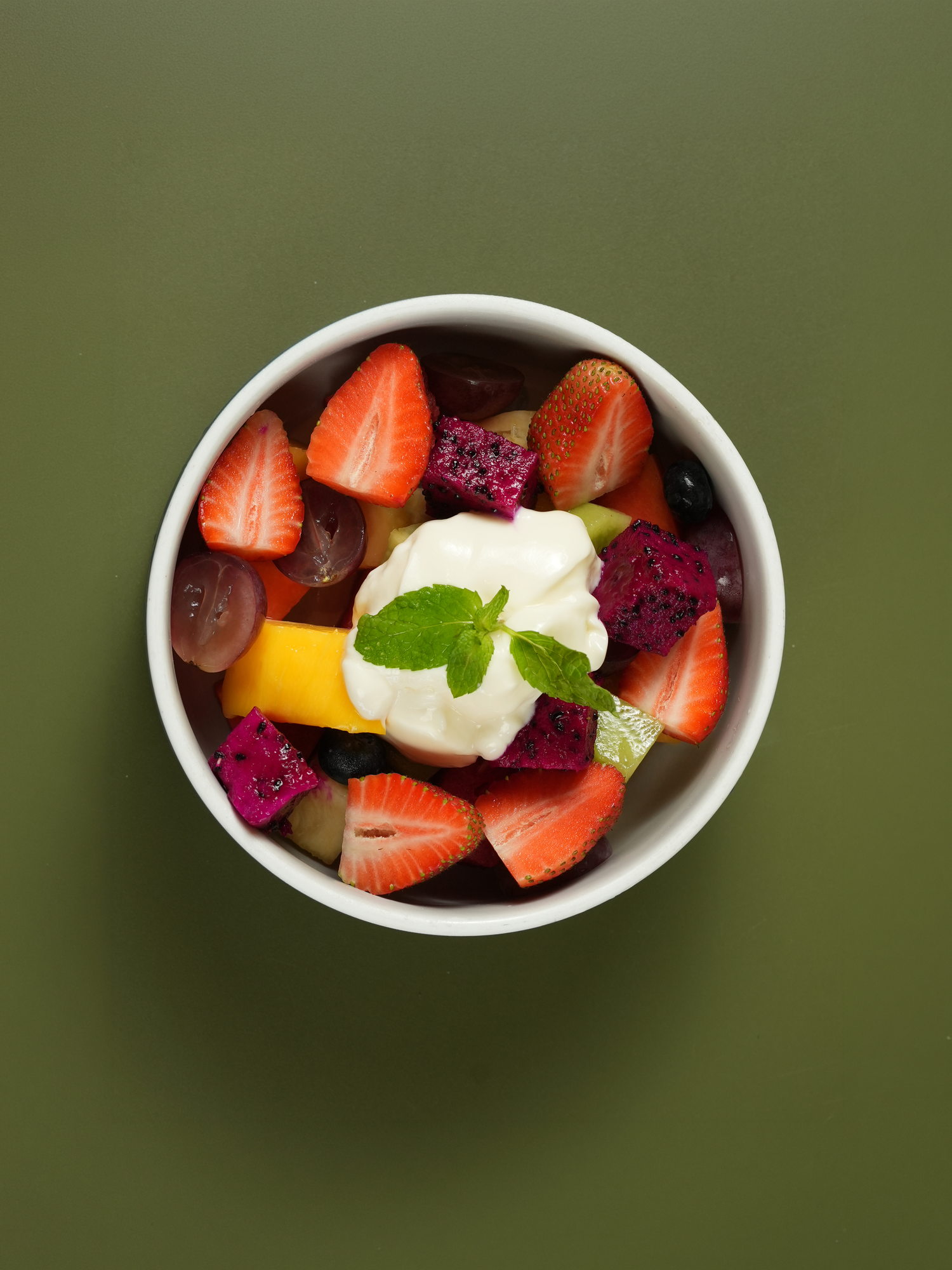 A bowl of strawberry, dragon fruit, mango, grape and kiwi topped with yoghurt and mint at The Shack, Paradisus by Melia Bali