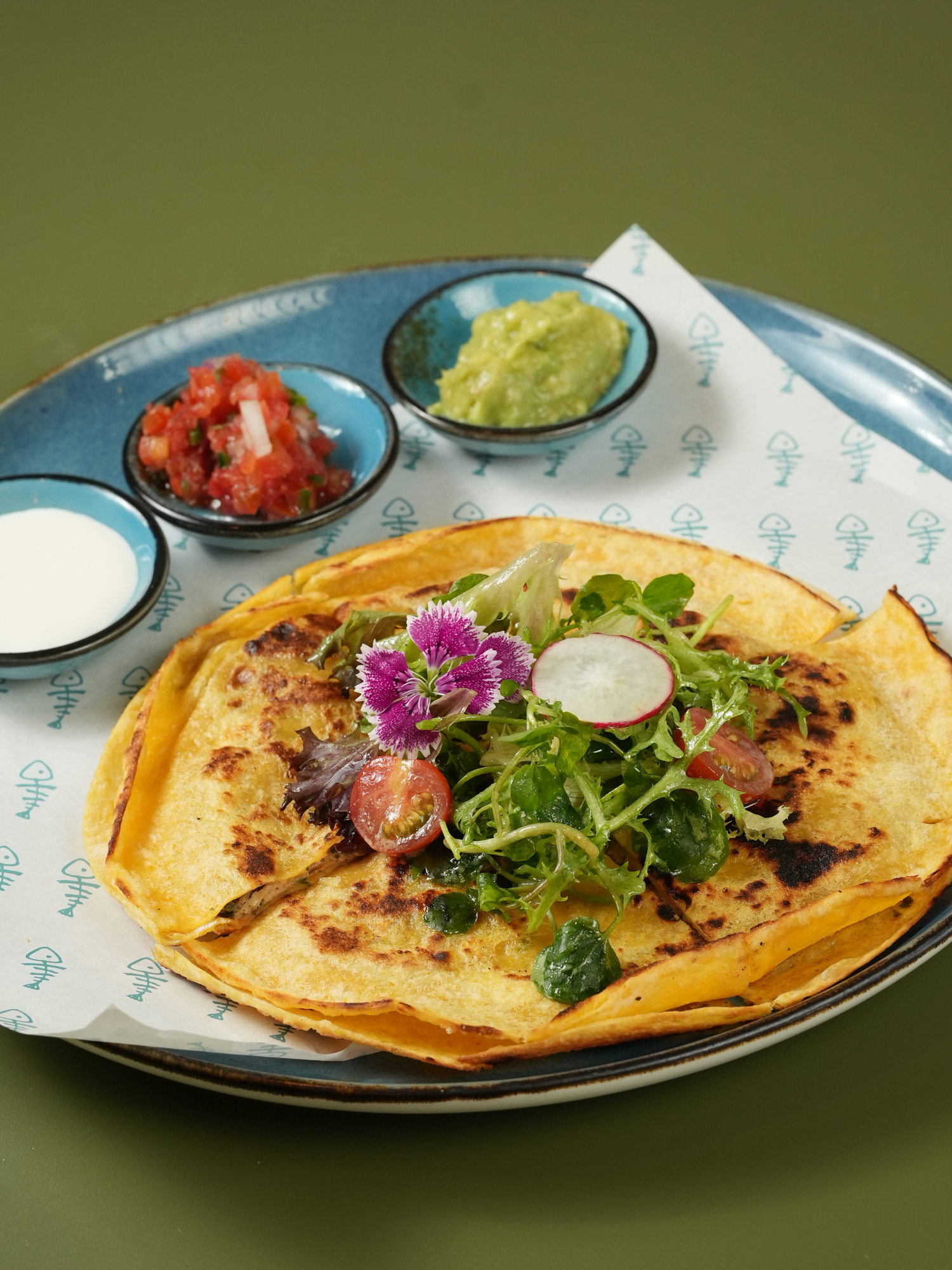 A quesadilla with a herb salad, served with salsa, guacamole and sour cream at The Shack, Paradisus by Melia Bali
