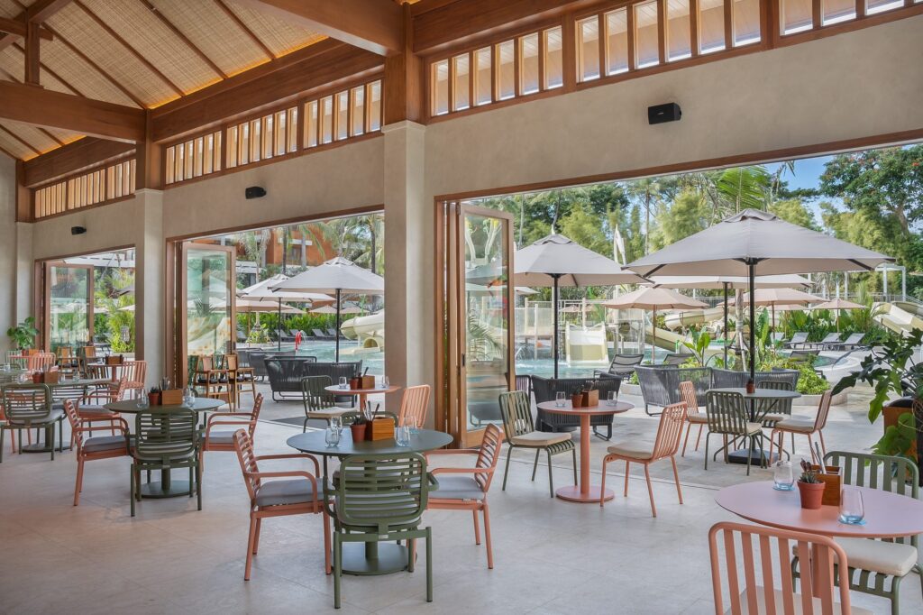 The Shack at Paradisus by Meliá Bali, casual tables opening onto the Aquazone Water Theme Park slides