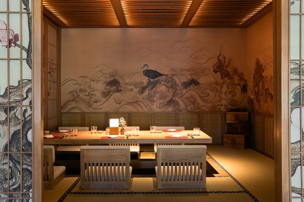 A private tatami room at Tokimeku Japanese restaurant, Paradisus by Meliá Bali, with a sunken table and a painted wave mural