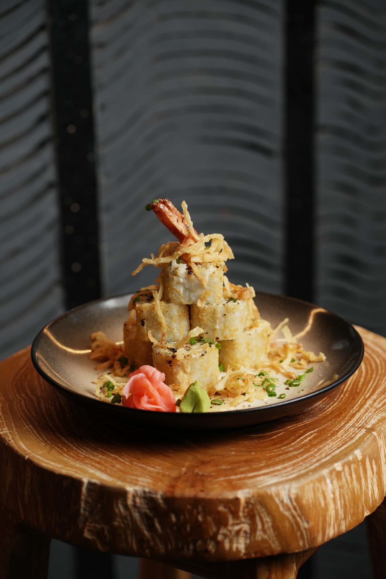 A stacked tower of tempura rolls topped with a prawn and crisp potato threads at Tokimeku, Paradisus by Melia Bali