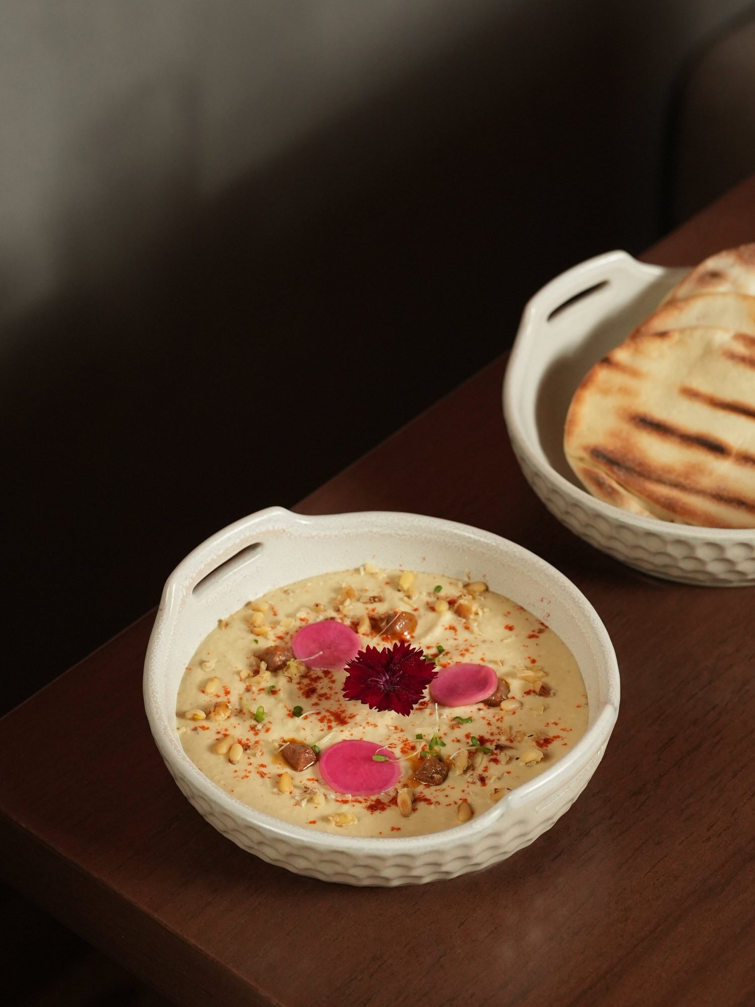 Hummus with pine nuts, walnuts, pickled radish and paprika, served with grilled pita at Samira, Paradisus by Melia Bali