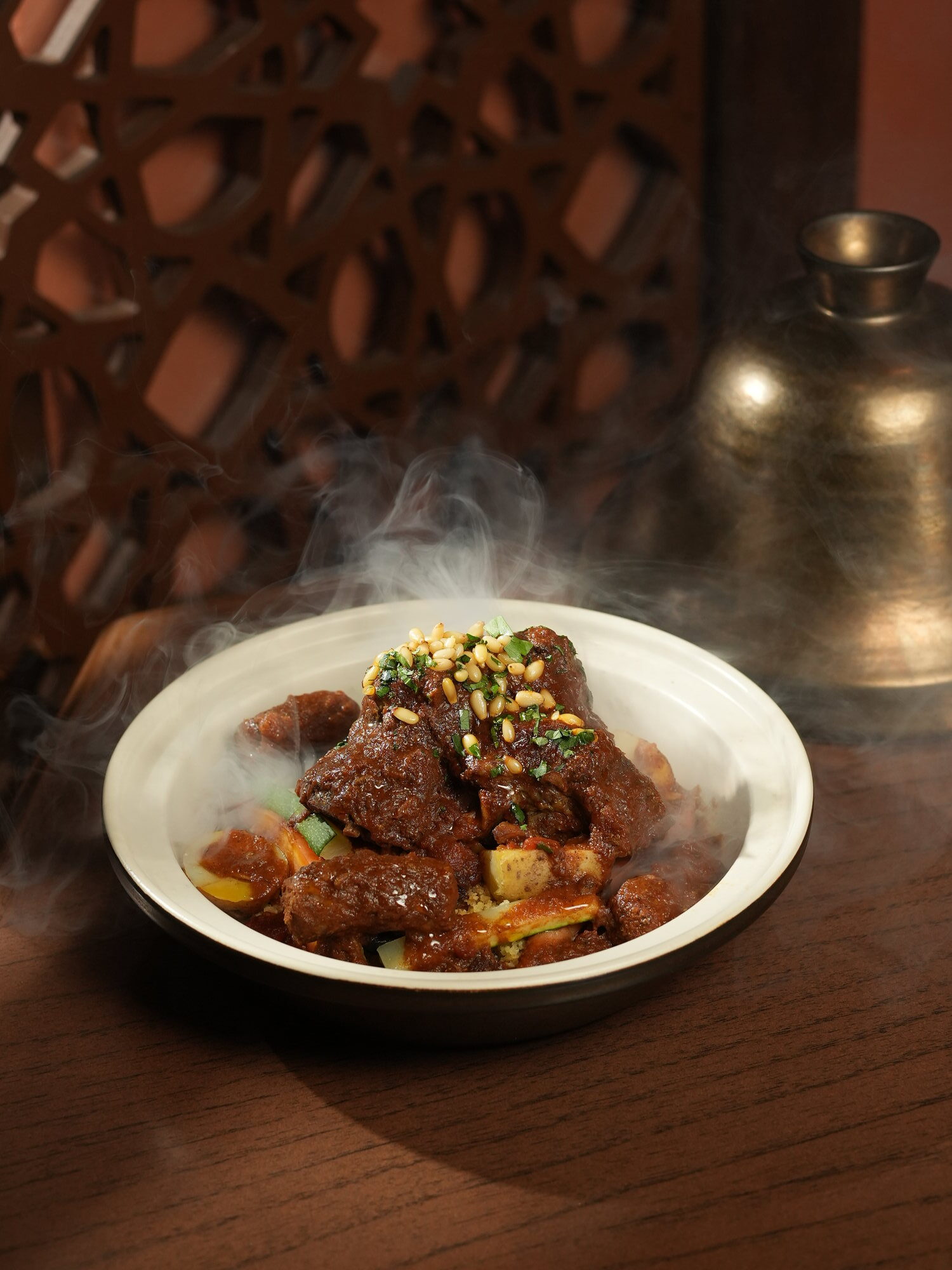 A steaming bowl of slow-cooked lamb with vegetables, couscous and toasted pine nuts at Samira, Paradisus by Melia Bali