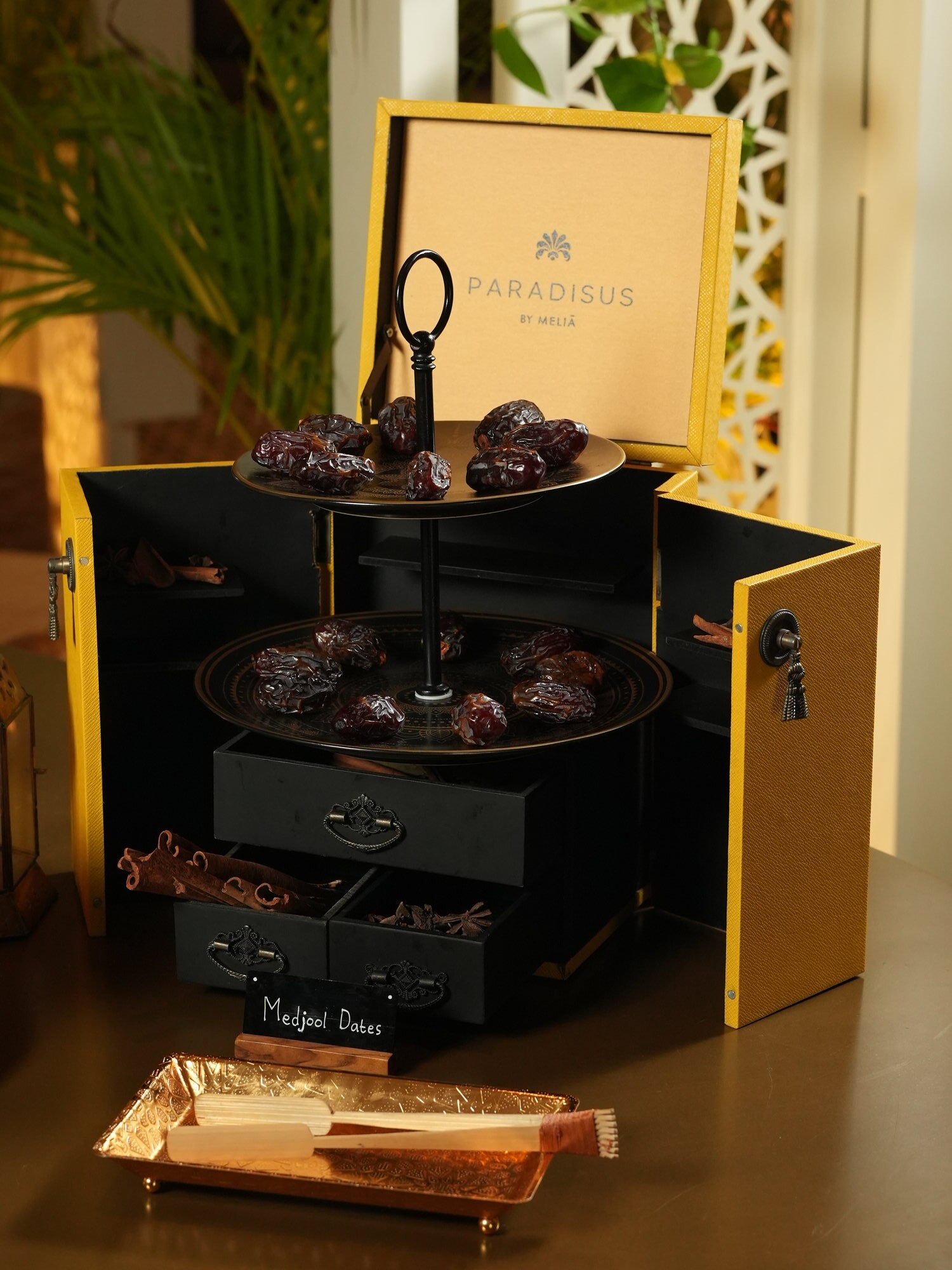 Medjool dates on tiered brass trays inside a yellow Paradisus chest at Samira, Paradisus by Melia Bali