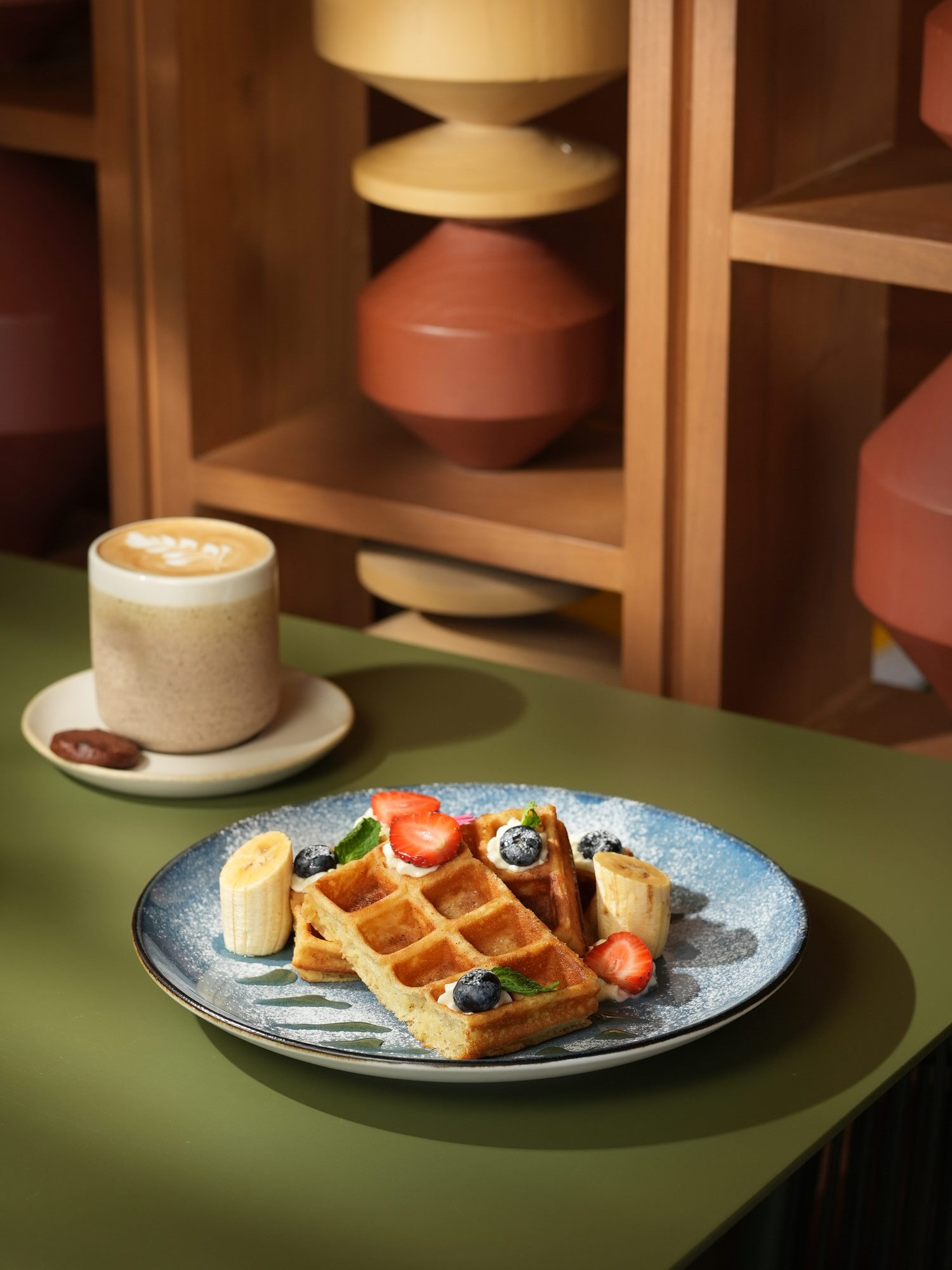 Waffles with strawberry, blueberry, banana and cream, with a latte and a chocolate cookie, at The Shack, Paradisus by Melia Bali